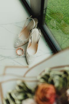Elegant bridal shoes with sparkling details beside a window. Perfect for wedding inspiration.