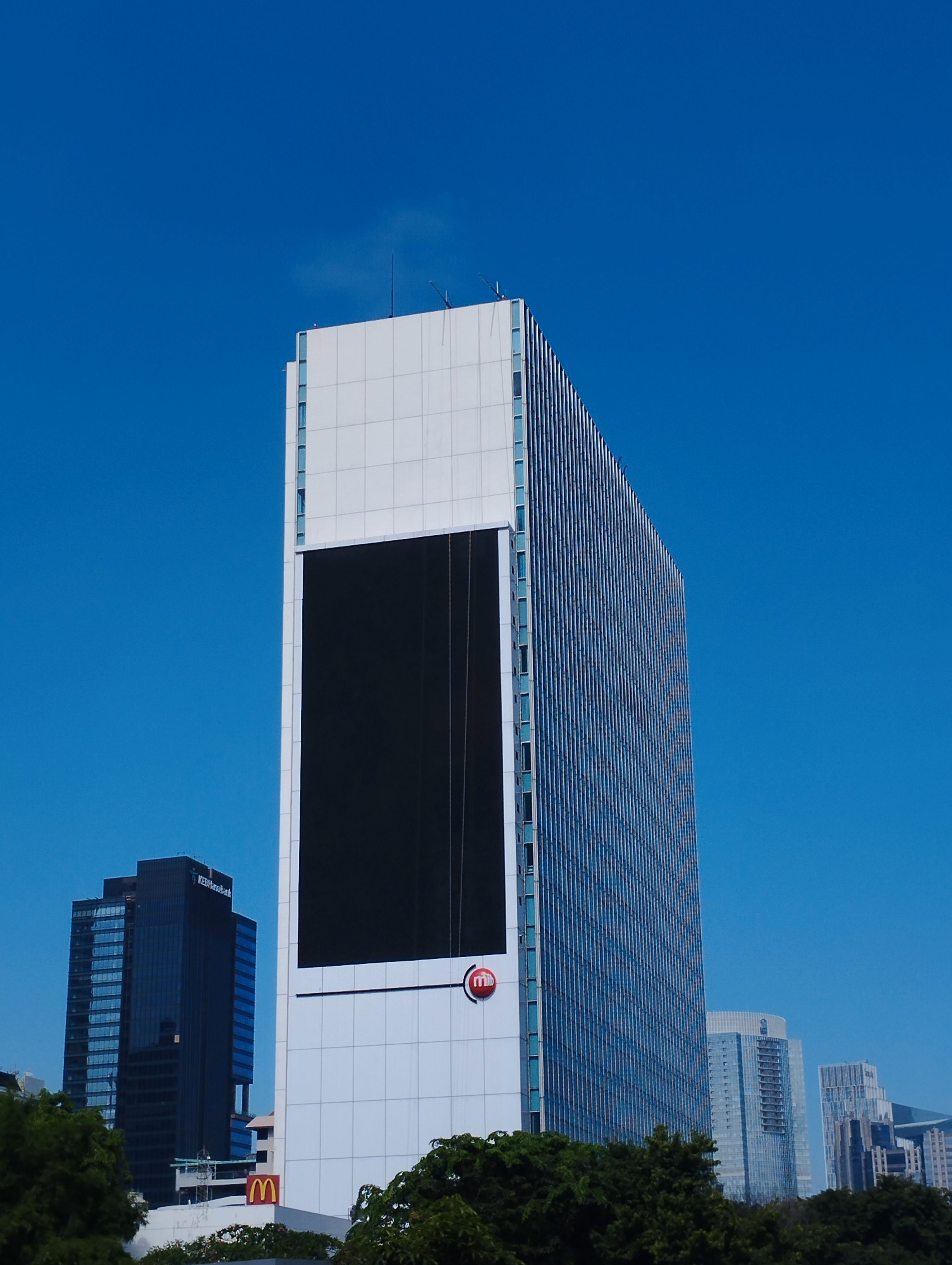 Modern Skyscraper Against Clear Blue Sky in Jakarta