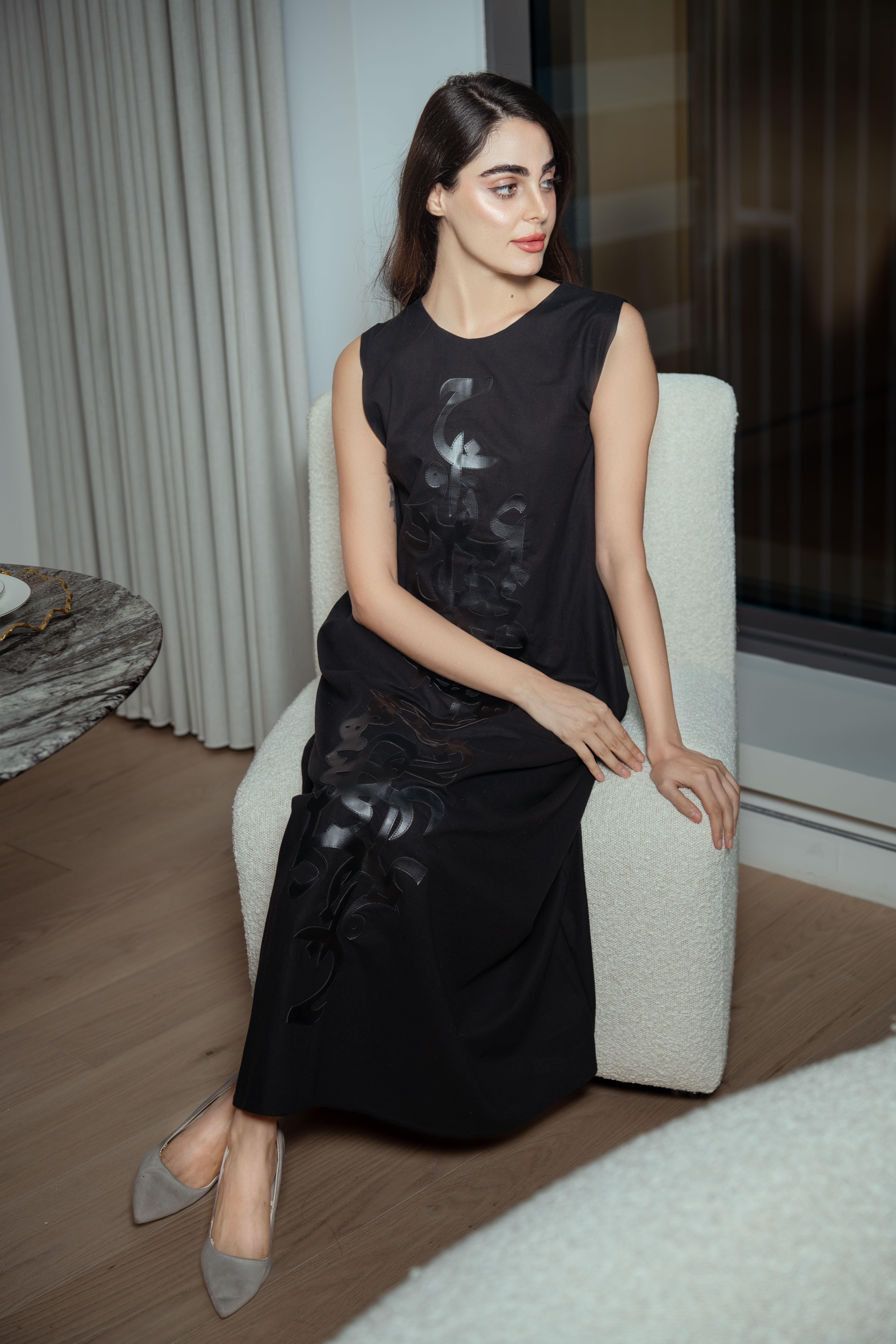 Elegant Woman in Black Dress Sitting Indoors · Free Stock Photo