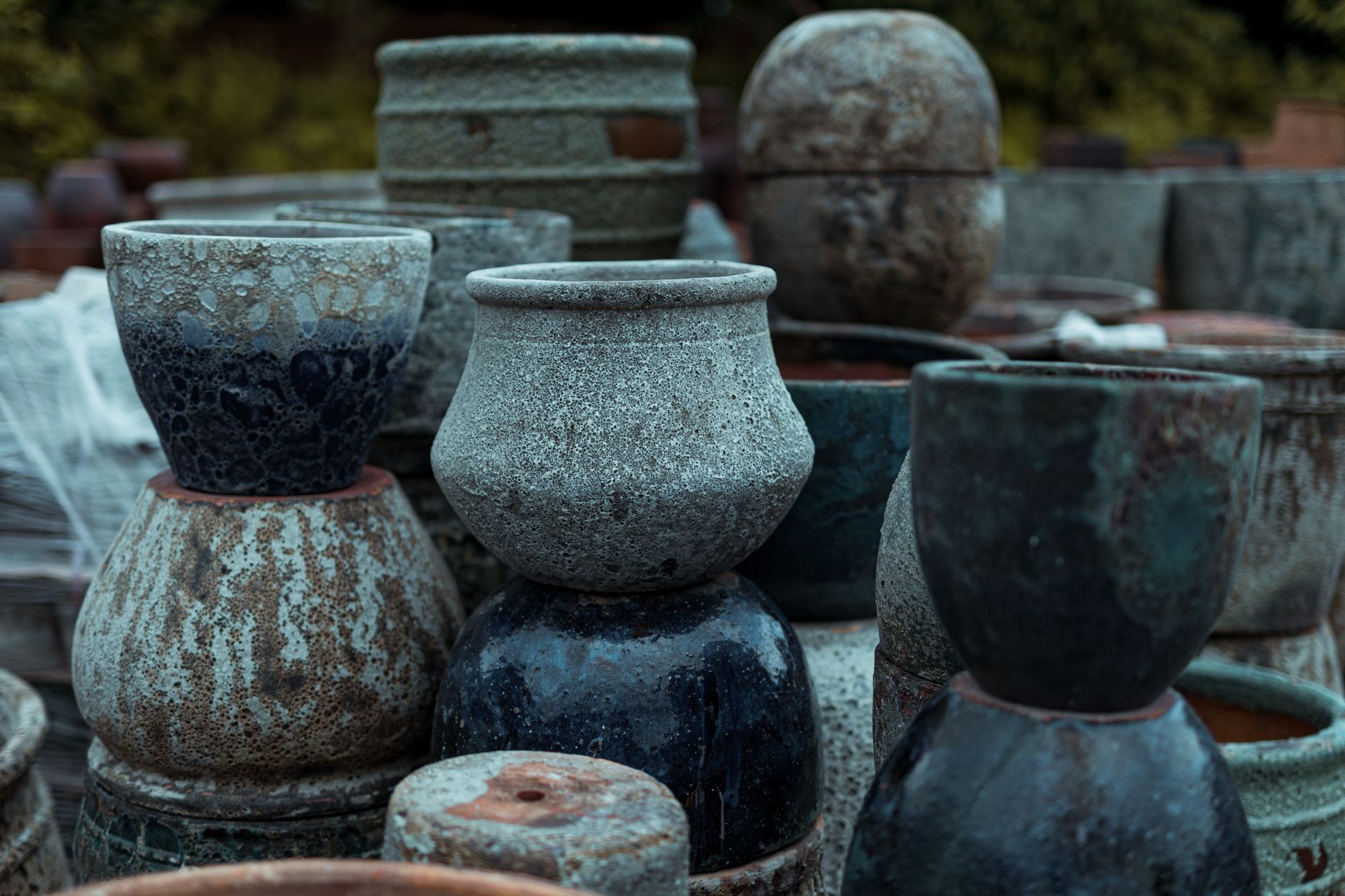 A collection of rustic ceramic pots on display in Bien Hoa, Vietnam.