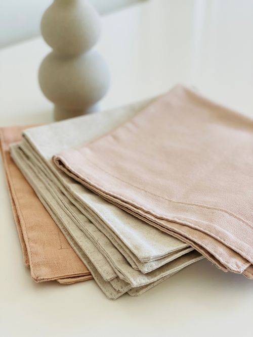 Folded stonewashed linen napkins, photo by Dijana Tandel on Pexels