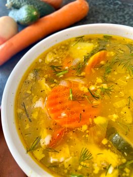 Warm vegetable soup with carrots, fresh herbs, and broth. Perfect for cozy meals.