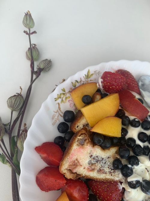 Free Delicious mixed fruit dessert with yogurt, served on an elegant floral plate. Stock Photo