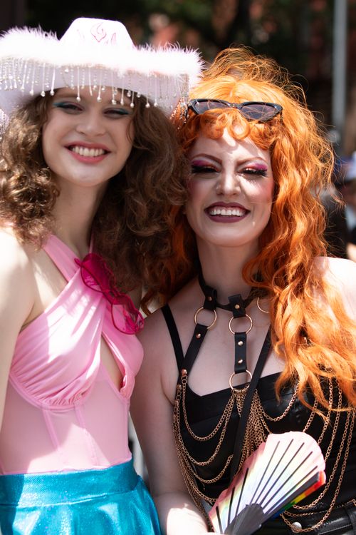 Free Two joyful participants at New York Pride Parade displaying diversity and unity. Stock Photo
