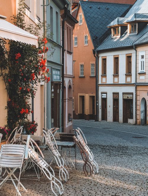 Free A quiet, picturesque street in Loket, Czechia with cozy outdoor café seating and historic architecture. Stock Photo