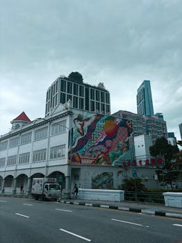 Vibrant street art on a Singaporean building, captured on a cloudy day.