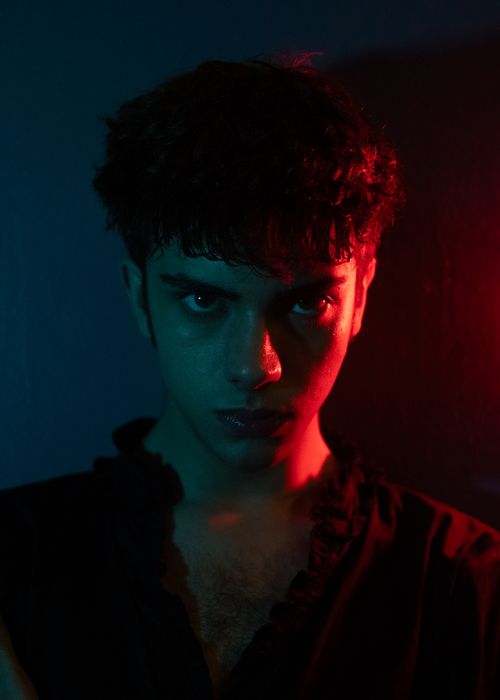 Free Dark and moody portrait of a man in dramatic red and blue lighting. Stock Photo