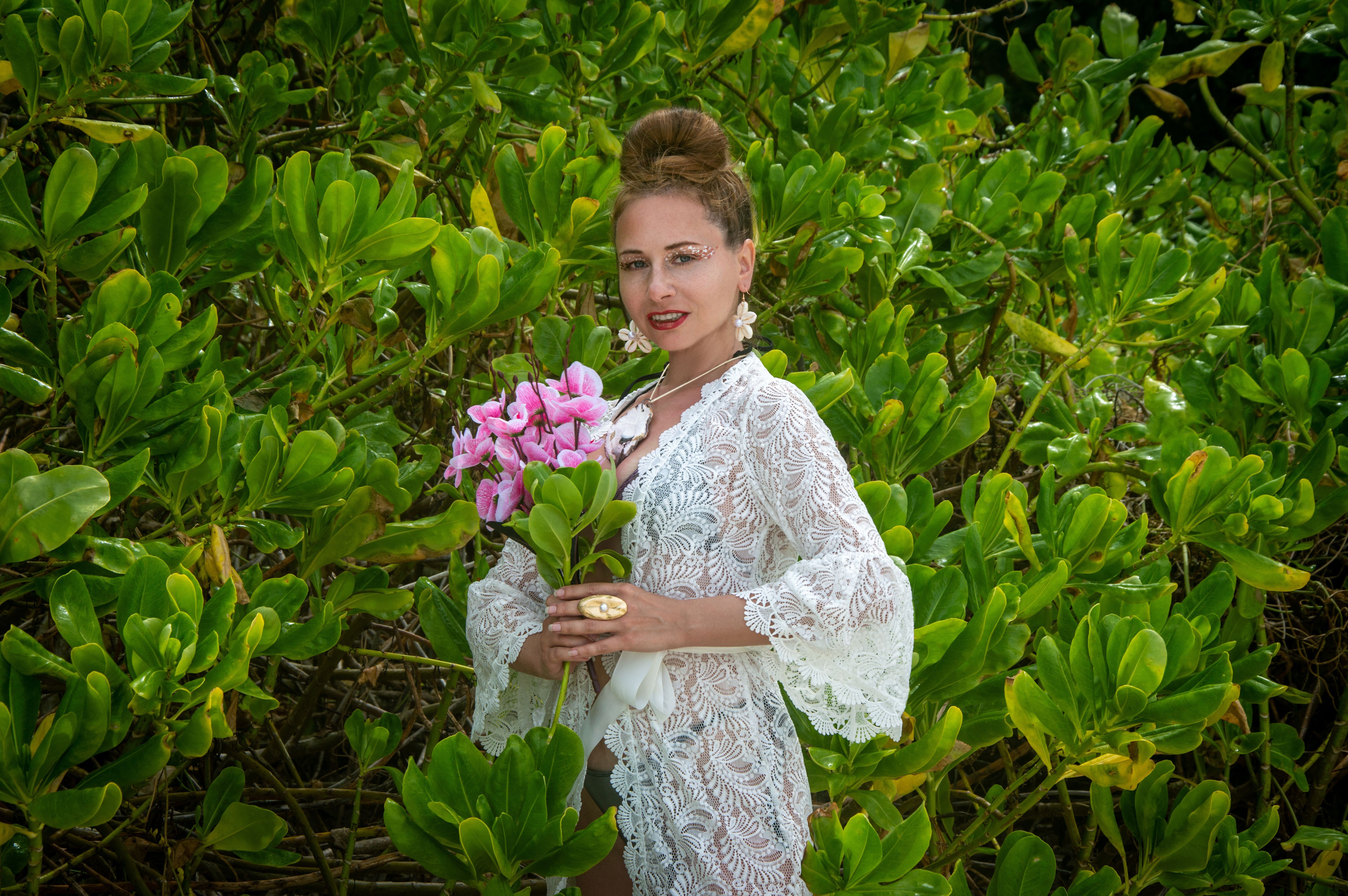 Woman in Lace Dress Holding Pink Flowers Outdoors · Free Stock Photo