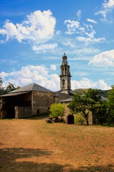 Scenic view of a historical church tower in Ourense, Spain against a vibrant sky.