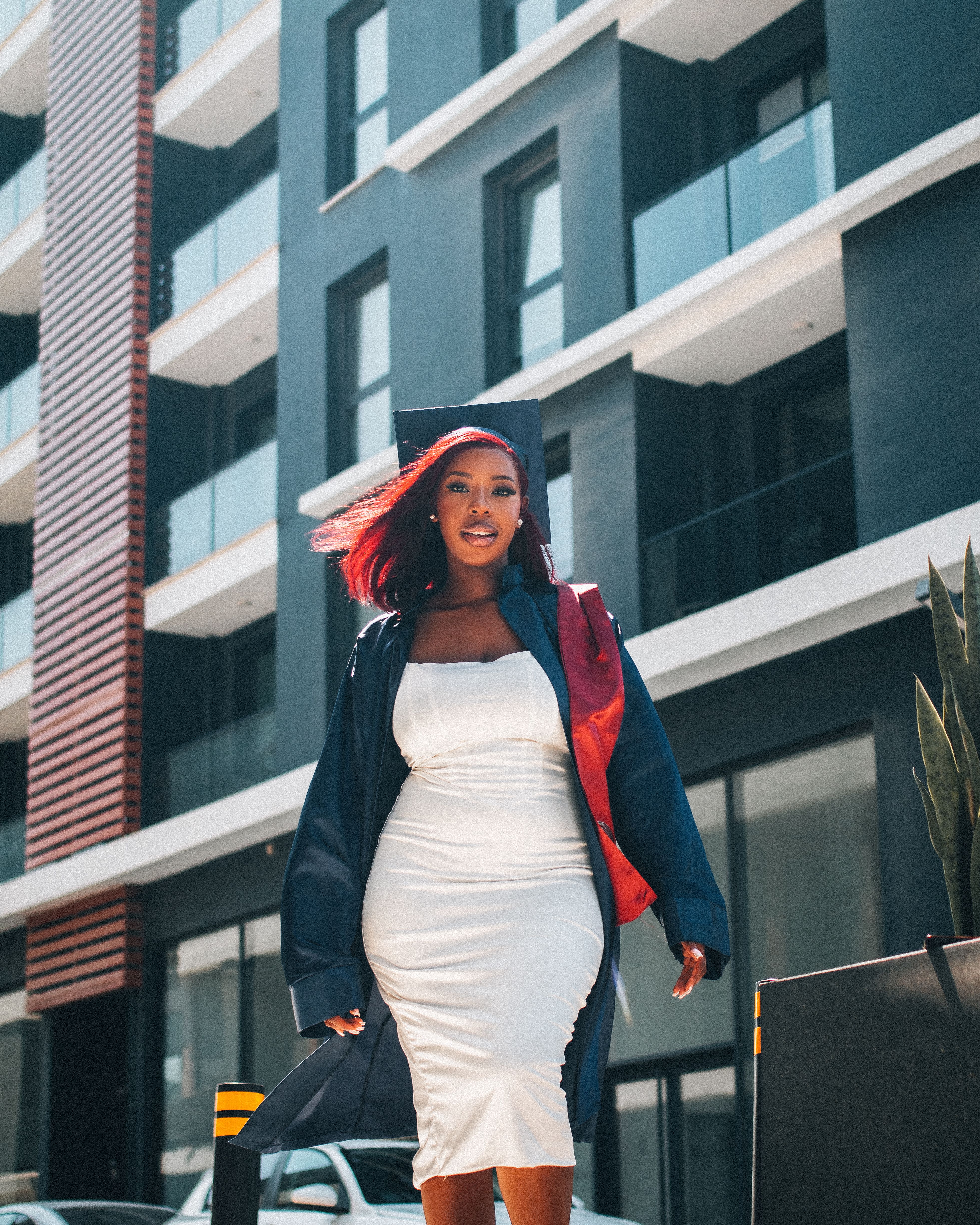 College Graduate Smiling in Graduation Attire · Free Stock Photo