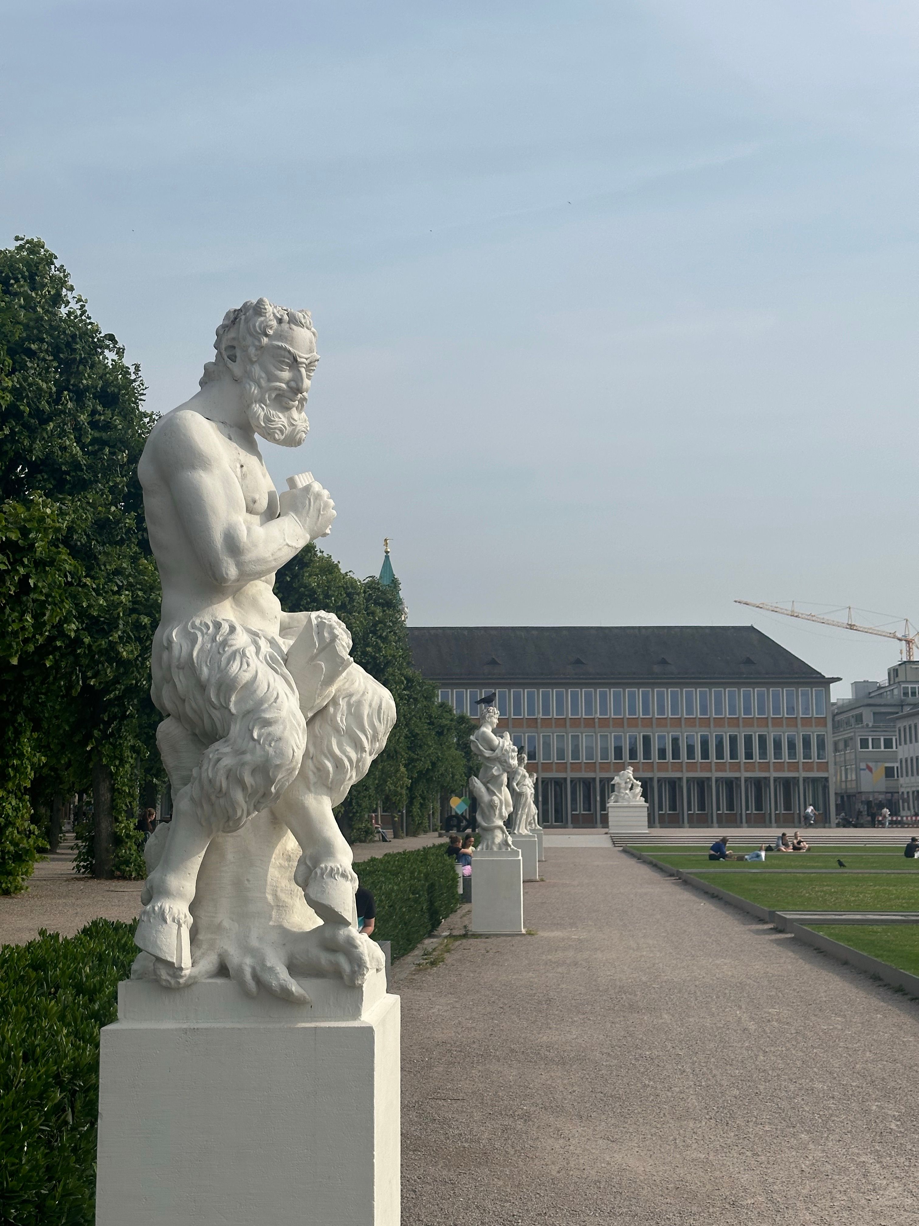 Free Row of white marble statues in a Düsseldorf park with clear sky Stock Photo