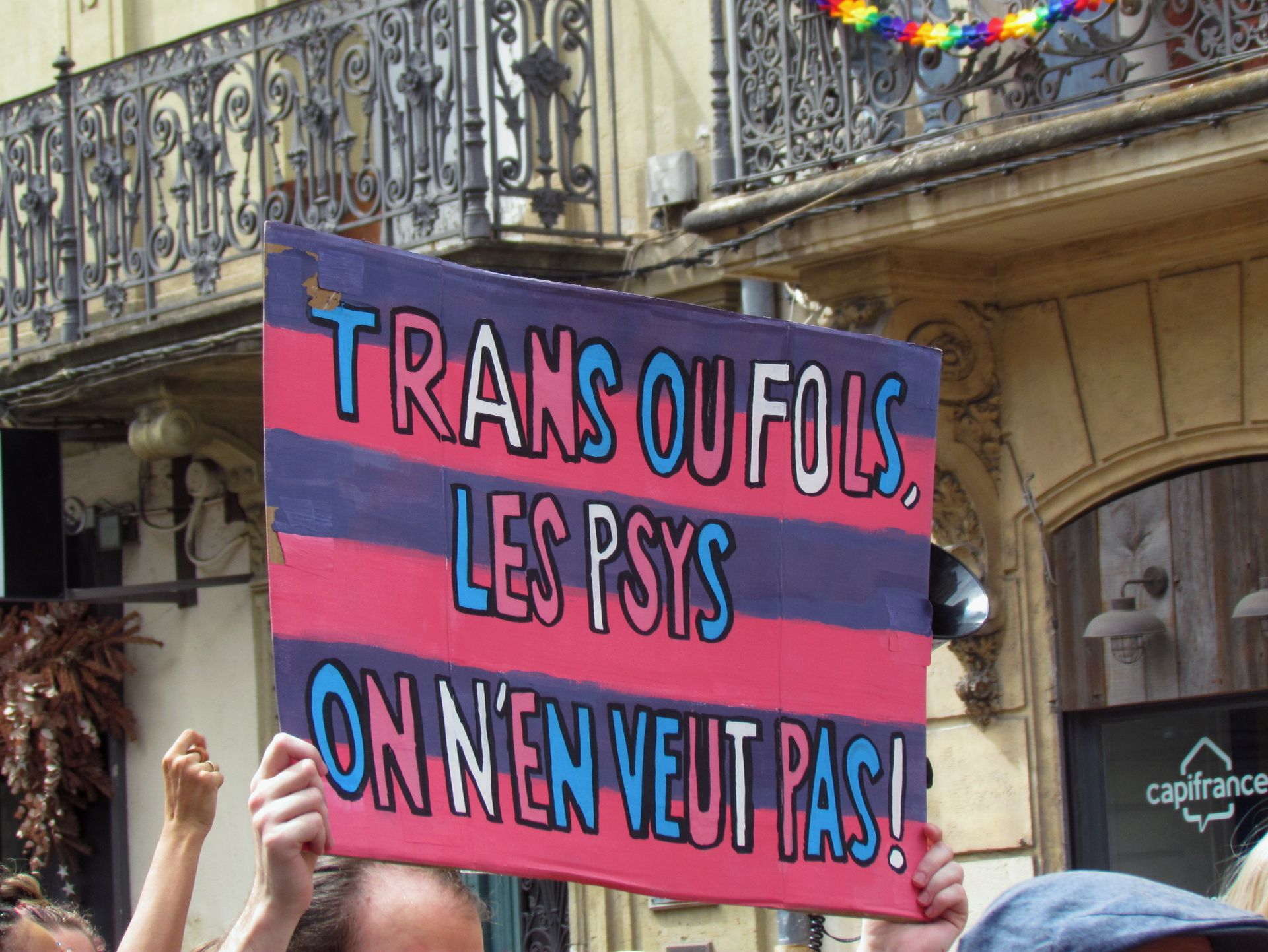 LGBTQ protest sign in a parade in France advocating for transgender rights.