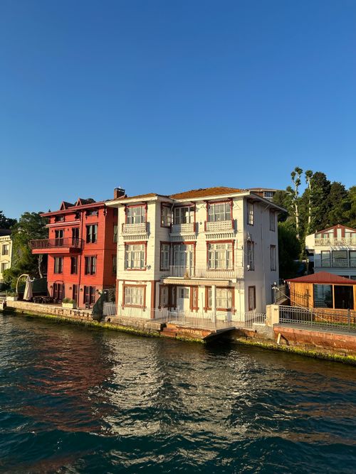 Free Elegant waterfront villas with traditional architecture along the Bosphorus at sunset. Stock Photo