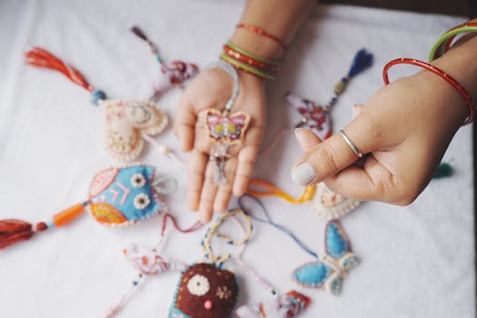 Vibrant handmade fabric ornaments including butterflies and hearts on display with hands holding them.