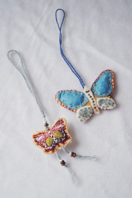 Free Vibrant handmade butterfly ornaments with intricate stitching and beading. Stock Photo