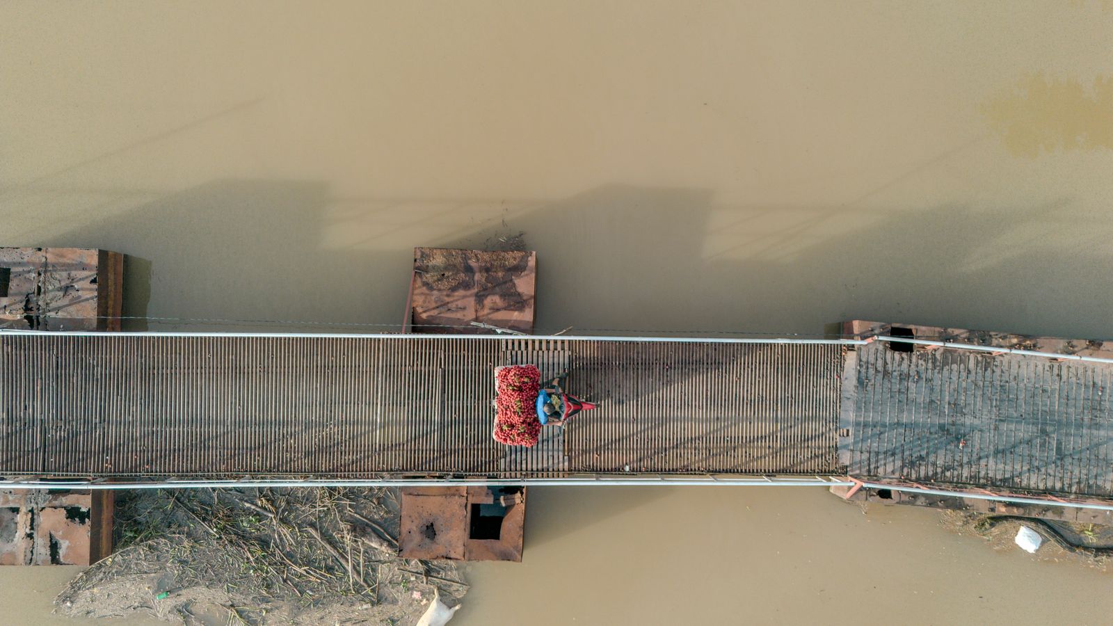 Lychee farmer on bridge in bac giang, Guinea-Bissau
