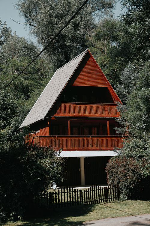 Free A picturesque wooden cabin nestled in a lush Hungarian forest, perfect for nature retreats. Stock Photo