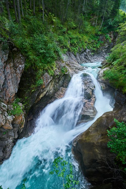 Free Breathtaking view of a waterfall surrounded by lush greenery in Krimml, Austria. Stock Photo