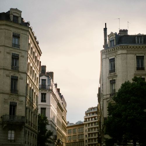 Free A tranquil view of historic buildings at sunset in Lyon, France. Stock Photo
