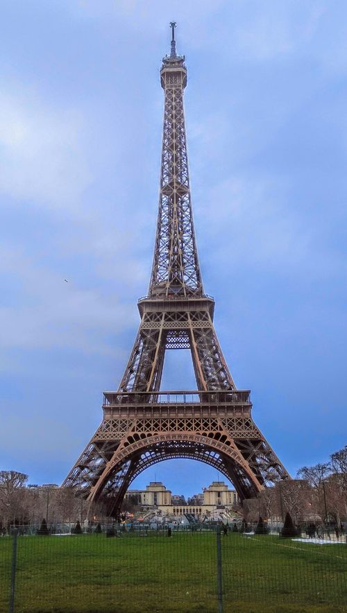 Free Capture of the iconic Eiffel Tower in Paris with a clear blue sky backdrop. Stock Photo