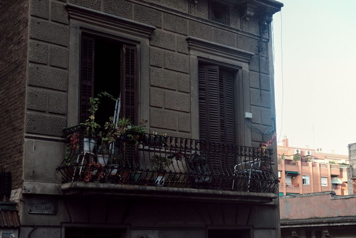 Balcon rustic plin de ghivece, pe o casa veche