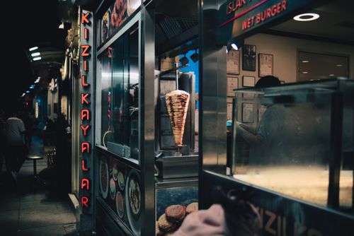 Free A vibrant night scene of a Turkish street food vendor in Istanbul with kebabs and wet burgers. Stock Photo