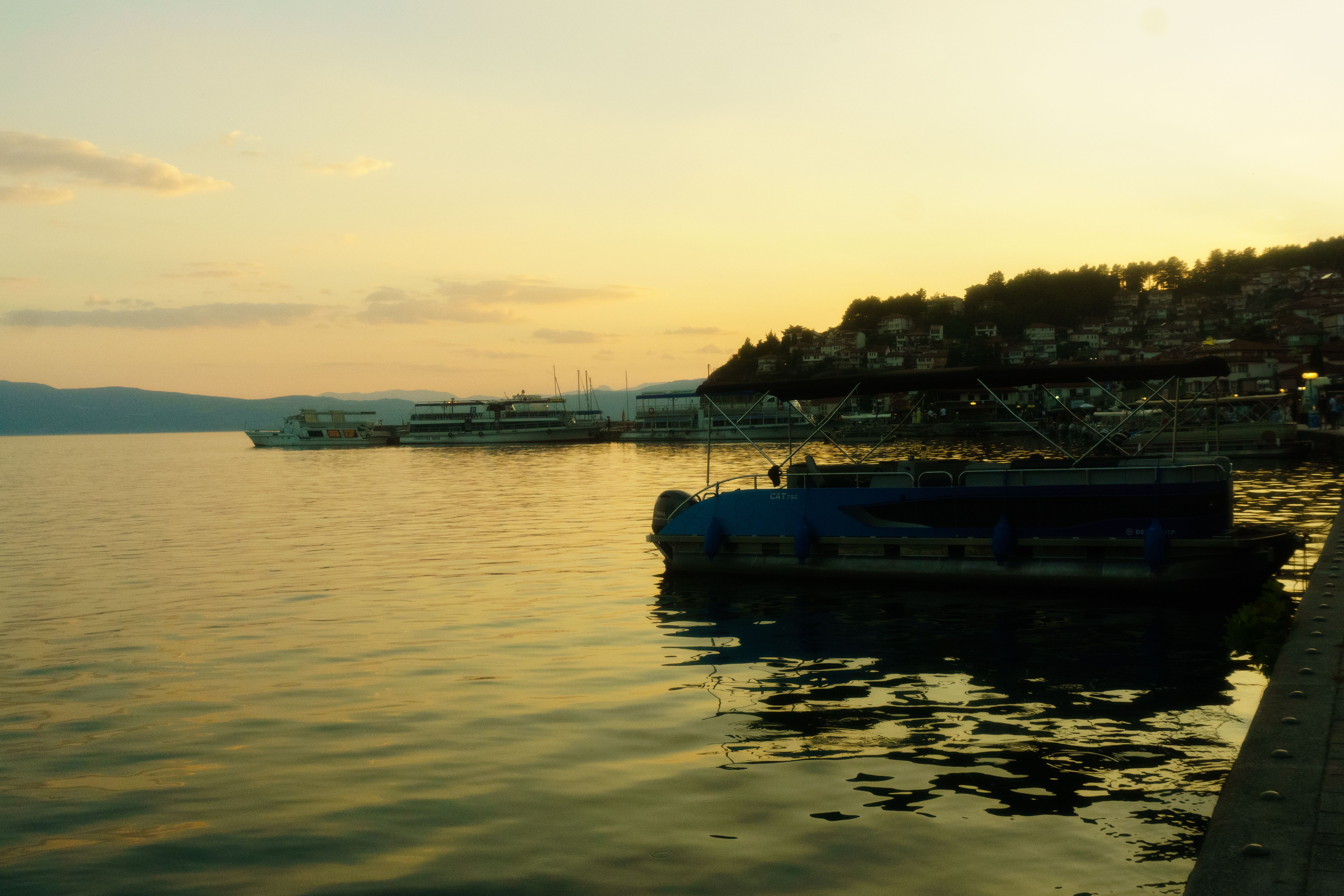 Traditional boat cruising on the clear waters of Lake Ohrid, North Macedonia
