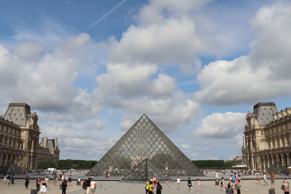 The iconic glass pyramid entrance of the Louvre Museum in Paris