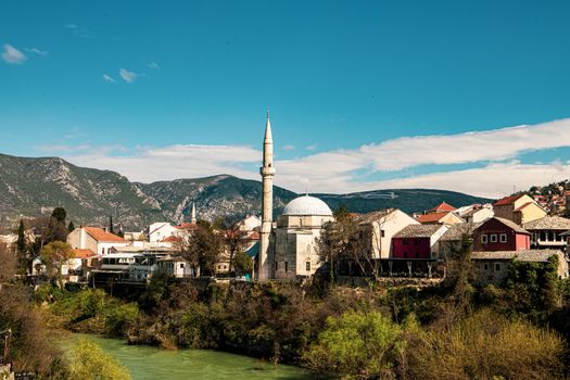 Charming landscape of Mostar, Bosnia, featuring a stunning mosque and scenic river view.
