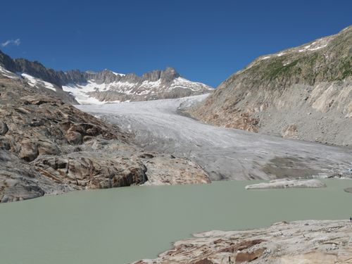 Free Stunning aerial view of Furka Pass glacier and glacier lake with surrounding mountains in Switzerland. Stock Photo