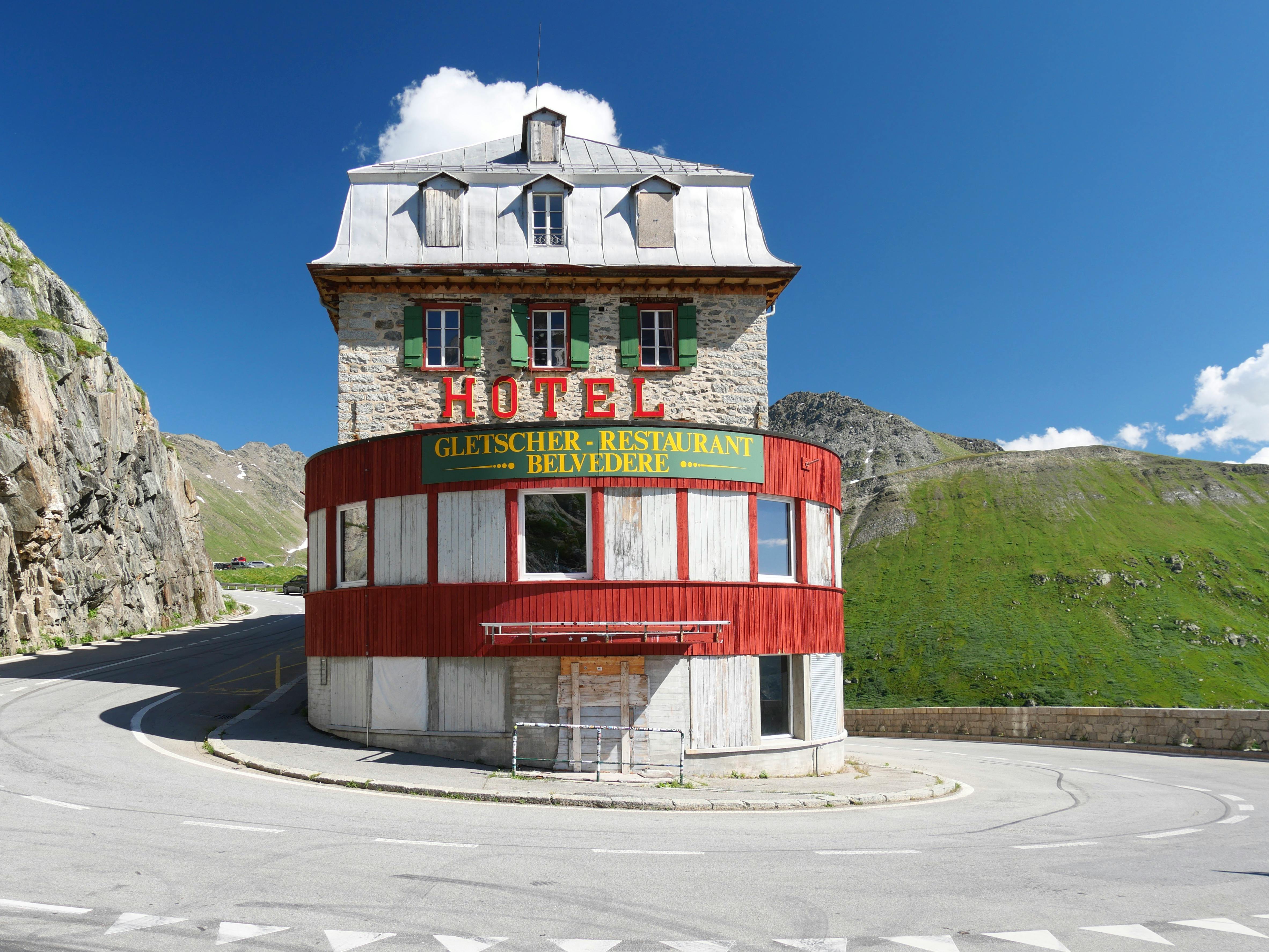 Abandoned Hotel Belvedere on Furka Pass, Switzerland with picturesque mountain backdrop.