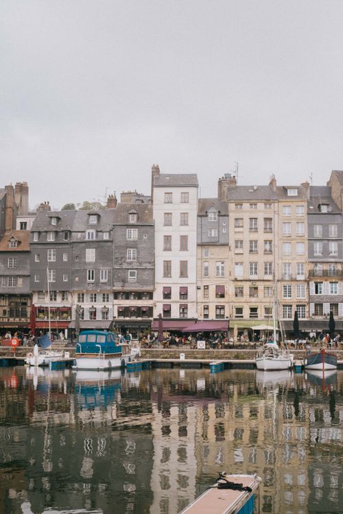 Free Scenic view of Honfleur's historic harborfront with colorful heritage buildings reflecting on the water. Stock Photo