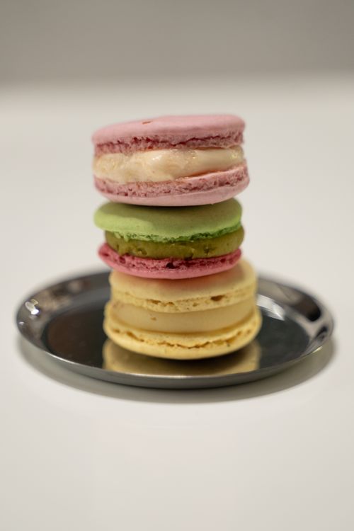 Free Vibrant stack of French macarons on a silver tray, showcasing dessert elegance. Stock Photo