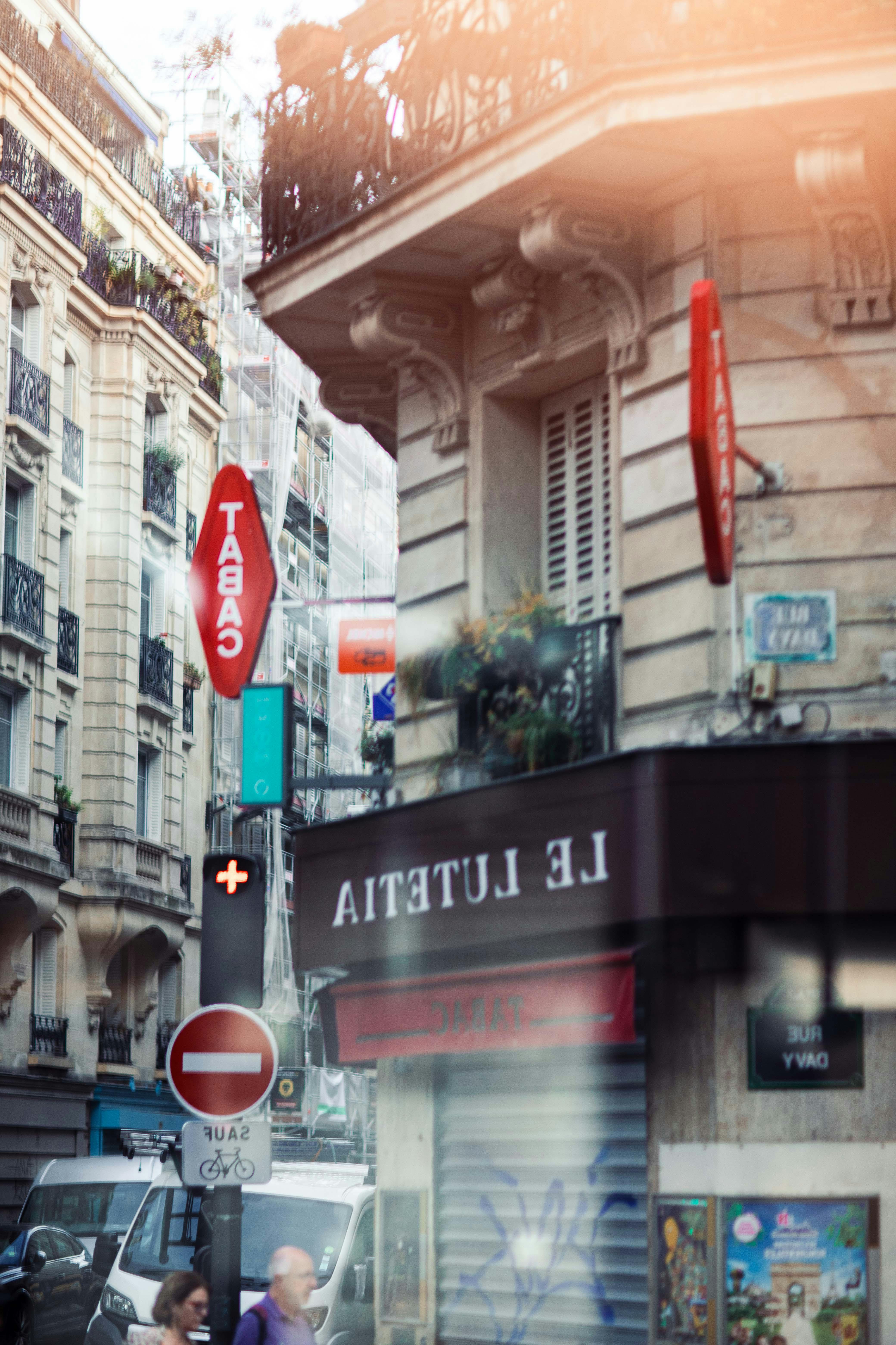 Quaint Paris street corner featuring classic architecture and a Tabac sign.