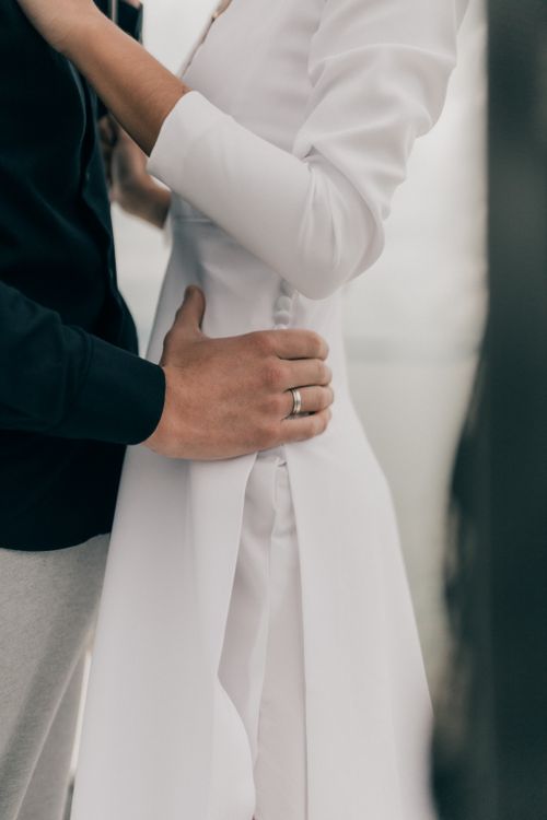 Free Close-up of a couple embracing, showcasing wedding attire and a tender moment. Stock Photo