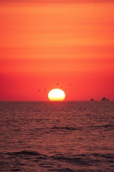 Stunning summer sunset at Miraflores beach with a vibrant sun setting over the ocean, creating a magical atmosphere.