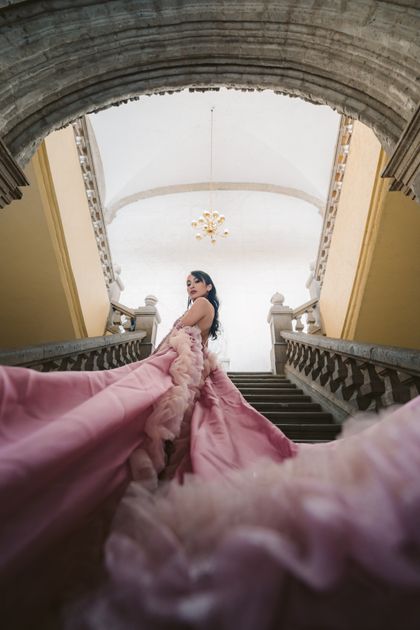 Woman in a flowing gown on a grand staircase — photo by Miguel Gonzalez on Pexels