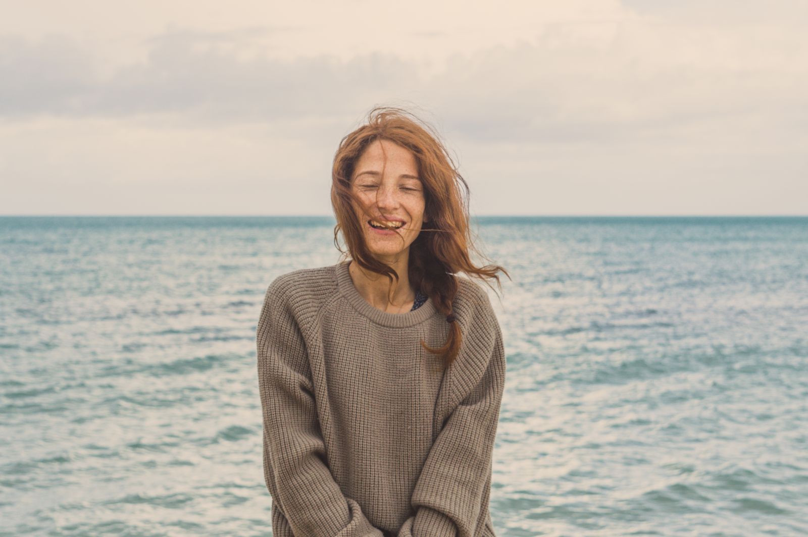 A woman in a fine knit sweater by the sea — Summer Knits, the best lightweight knits of 2026