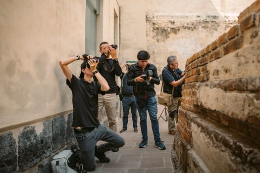 Photographers capturing shots at a historic location in Mexico City. Artistic exploration in an urban setting.