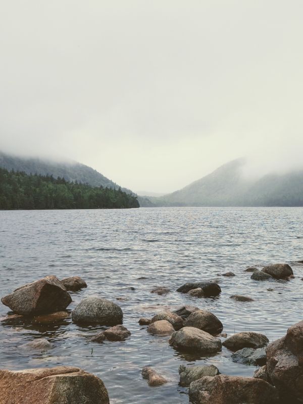 Mist over a still mountain lake, photo by David Yu on Pexels