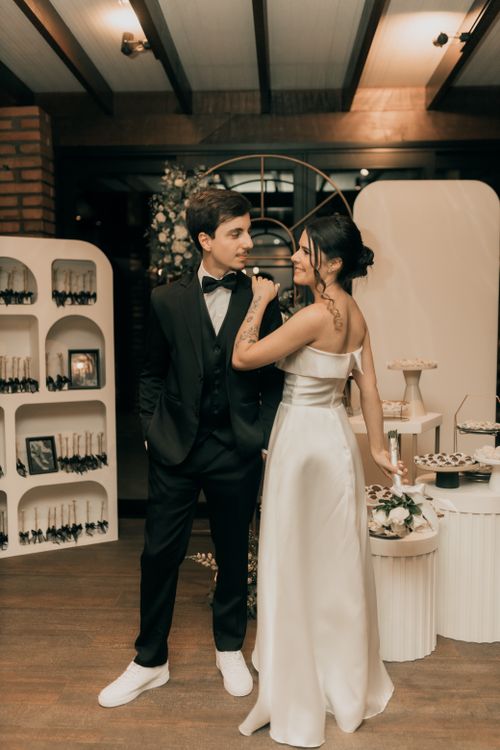 Free Bride and groom in elegant attire at a modern indoor wedding reception. Stock Photo