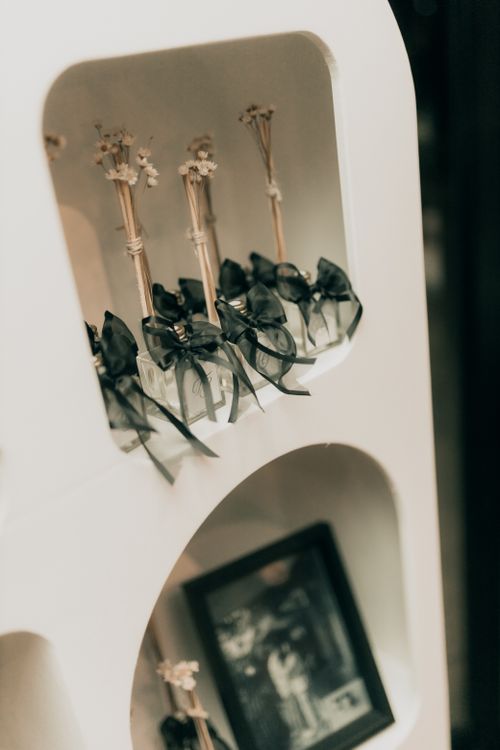 Free A decorative shelf with photo frames and elegantly arranged ornaments, perfect for home styling. Stock Photo
