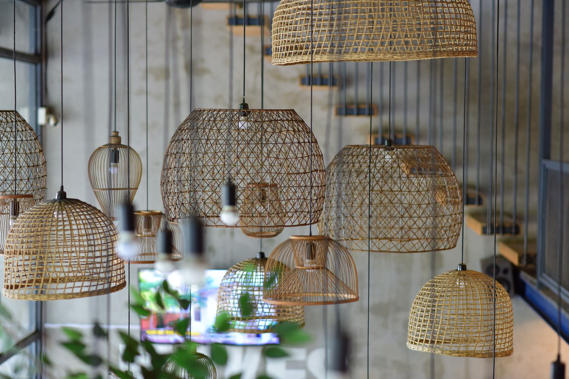 Stylish rattan pendant lights in a contemporary urban cafe interior, creating a warm ambiance.