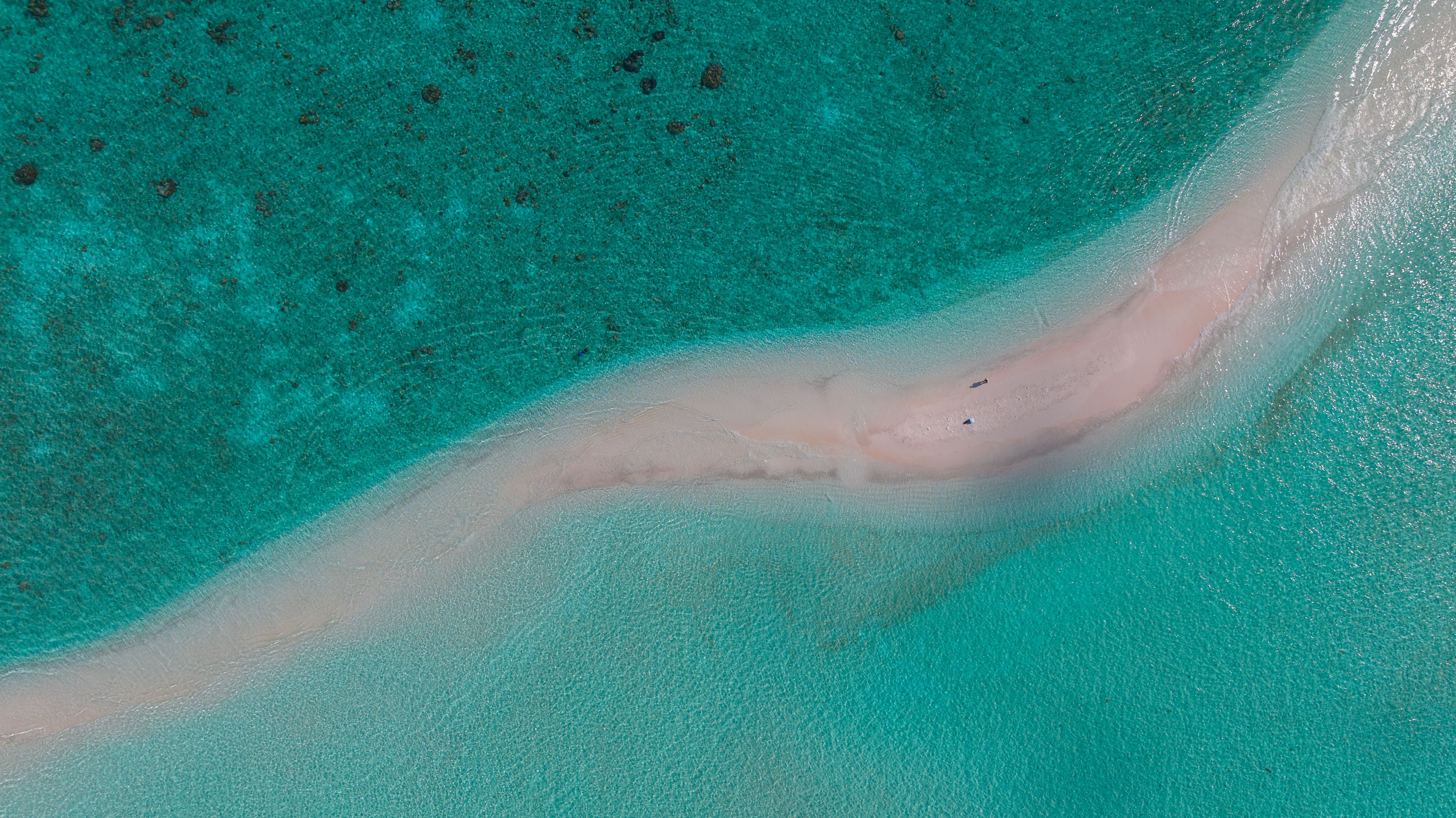 Breathtaking aerial shot of a picturesque Maldives beach and turquoise ocean waters, ideal for travel inspiration. Breathtaking aerial shot of a picturesque Maldives beach and turquoise ocean waters, ideal for travel inspiration.