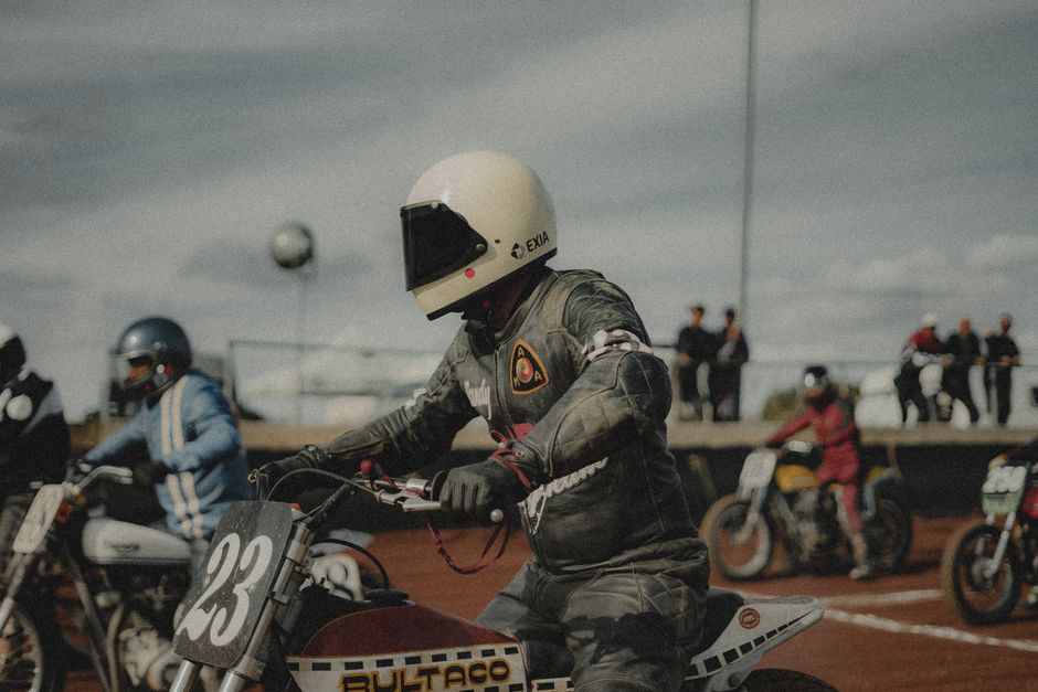 Motorcycle racers in action during an exhilarating dirt track event, showcasing speed and skill.