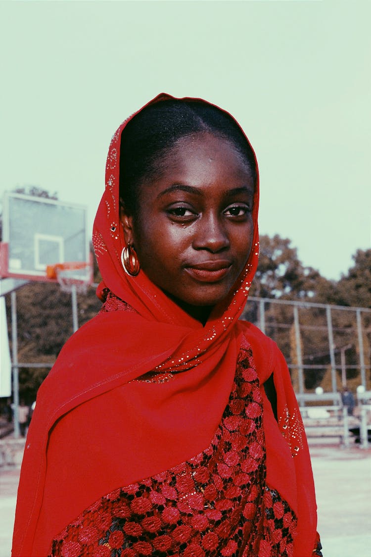 Confident Black Woman In Colorful Clothes On Sports Ground