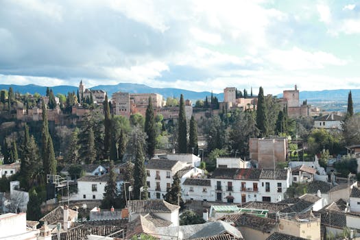 Breathtaking vista of Alhambra palace overlooking Granada's historic rooftops.