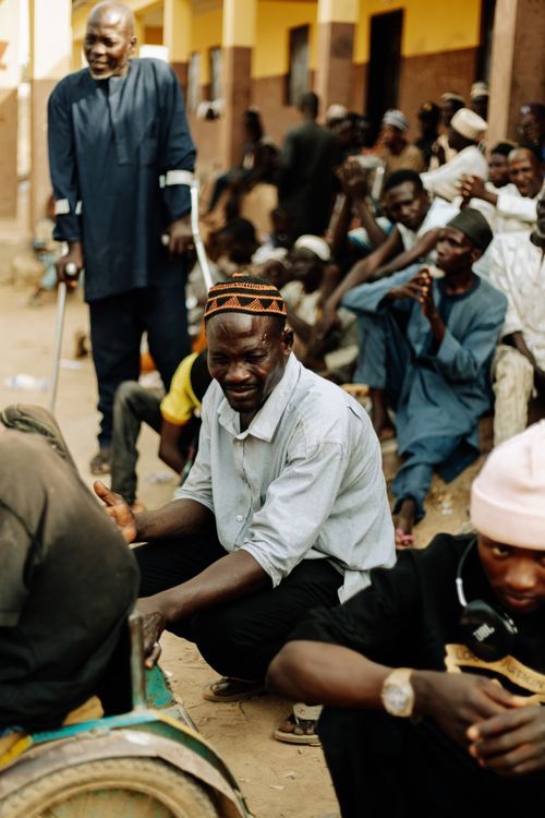Free A group of people gathered outdoors, engaging in conversation and activities. Stock Photo