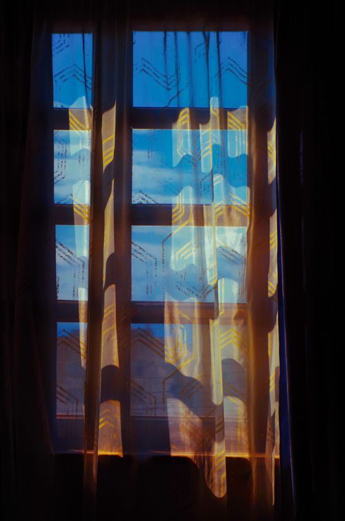 Free Sunlight streaming through sheer curtains, casting patterns on a window in Tbilisi, Georgia. Stock Photo