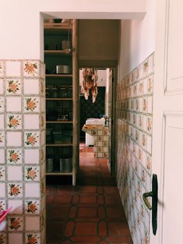 Cozy vintage kitchen space with floral tiles and warm lighting.